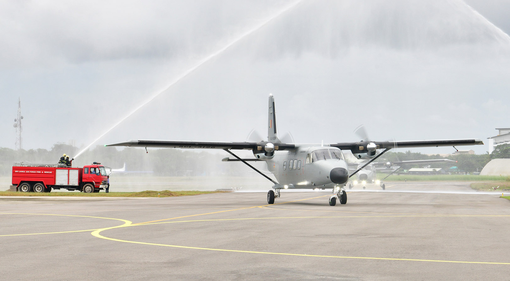 The two brand new Y-12 IVs get a traditional water salute by the fire department during their delivery (Image: SLAF)